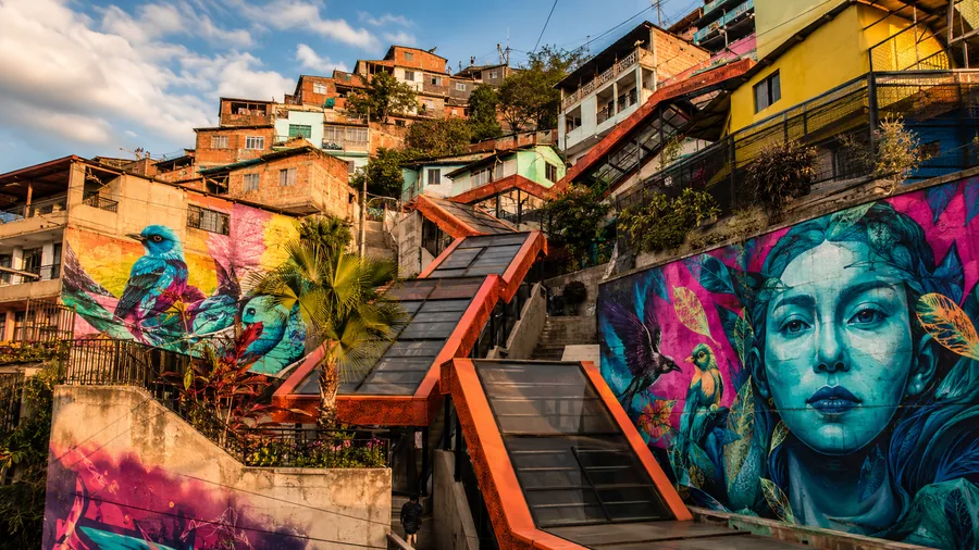 Colorful graffiti murals and the famous orange outdoor escalators in Comuna 13, Medellín