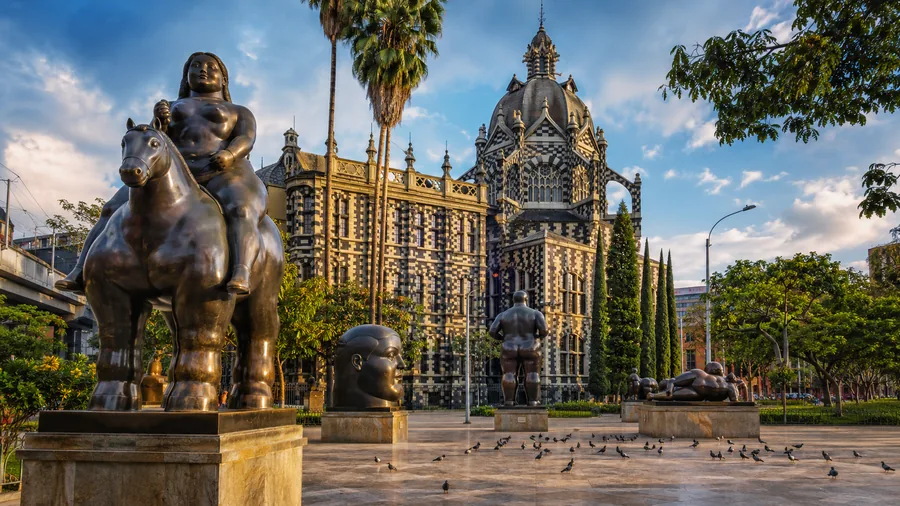 Plaza Botero with Fernando Botero's bronze sculptures and the striped Rafael Uribe Uribe Palace of Culture behind